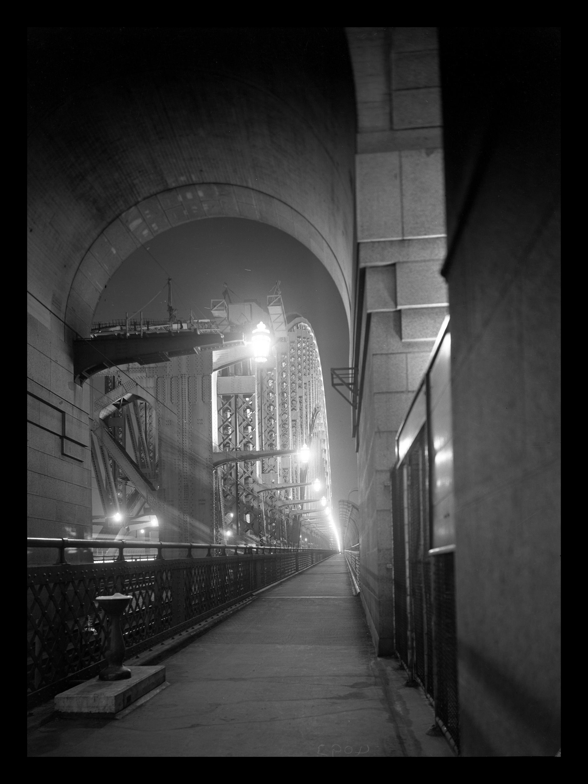 Sydney Harbour Bridge c.1938 - Sesquicentennial floodlighting from under the south pylon. NRS-21243-2-3-1348