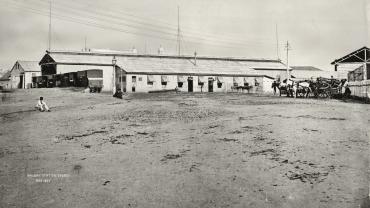 First Sydney Railway Station, 1871, showing the remains of the old tramway tracks (where man is sitting). The Goods Shed is on the far left and the platform on the right side became the George St Platform (No. 11). Digital ID 17420_a014_a0140000245 First Sydney Railway Station, 1871, showing the remains of the old tramway tracks (where man is sitting). The Goods Shed is on the far left and the platform on the right side became the George St Platform (No. 11). Digital ID 17420_a014_a0140000245
