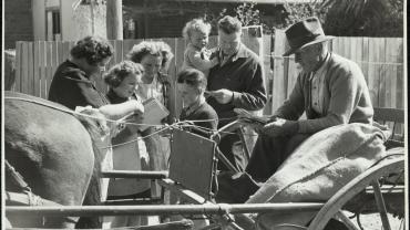 The mailman calls at a country home with letters for all, and State Correspondence School lessons for the youngsters. He will take away with him all completed exercises from the previous school delivery. The mailman will collect all completed school exercises from the previous delivery