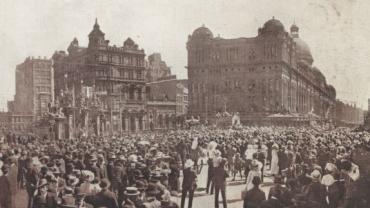 Crowds watching the eight-hour day procession passing St Andrews, Town Hall and the QVB before heading up Park Street, Sydney, 1915. NRS 20499 